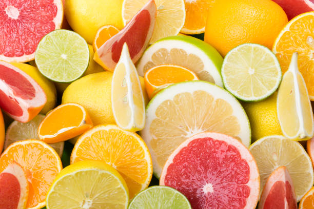 istock many multicolored cut citrus fruits lie together as a background, grapefruit mandarin, lemon 931409842