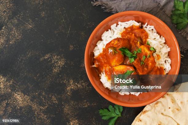 Chicken Korma With A Spicy Sauce Over White Ricetraditional Indian Dish On A Rustic Background Top View Copy Space Stock Photo - Download Image Now