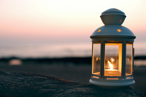 glowing lantern with Blurred Seaside sunset background