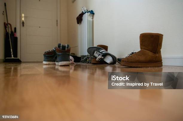 Untidy Hallway With Hardwood Floor And Plenty Of Shoes Stock Photo - Download Image Now