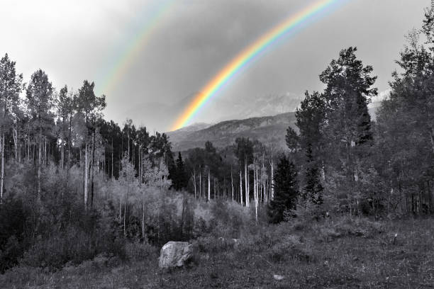 Double rainbow above black and white mountain landscape in Colorado