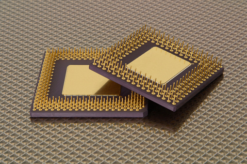 A pattern of microprocessor circuits on a silicon wafer. The semiconductors or central processing unit CPU microchips are fabricated from a silicon wafer with patterned layers of various materials.