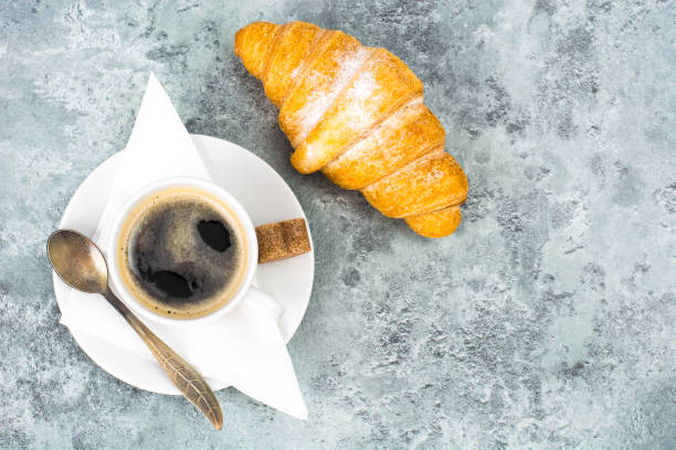 istock Aromatic hot coffee with croissant for breakfast. Studio Photo 931428312