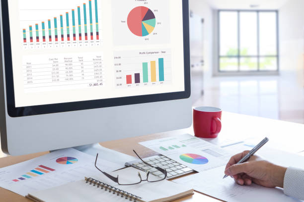 istock Businessman in front of modern computer with colorful pie graph analysing business performance accounting. 931428458