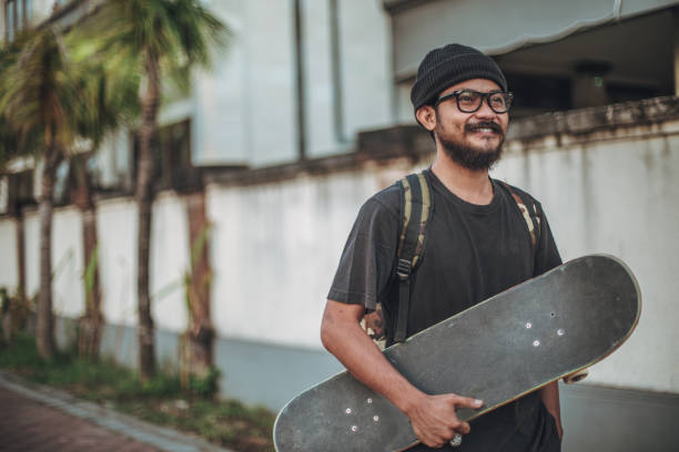 istock Man holding a skateboard outdoors 931441018