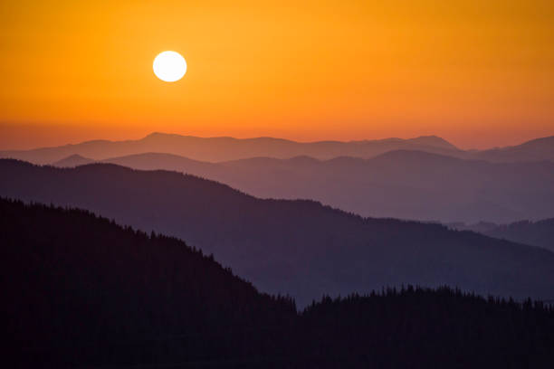 istock Sunset with deep orange colors over the distant hills 931446116