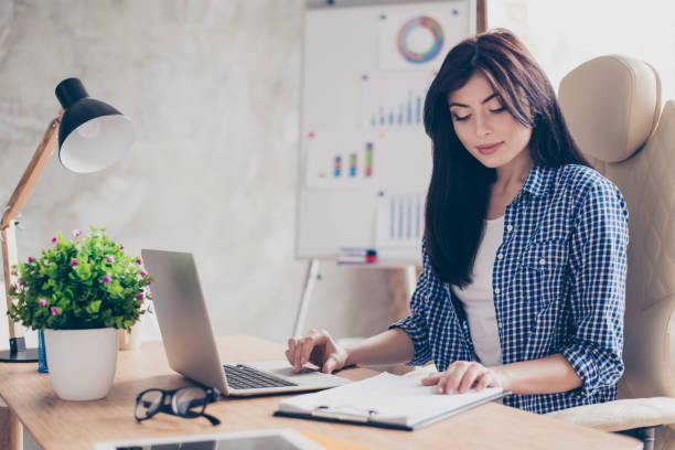 istock Leadership quality success expert experience education examine internship training practice concept. Confident concentrated pretty agent controlling the document on table searching in netbook 931446418