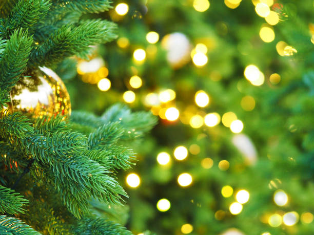 istock Christmas tree with holiday golden decorations and lights. Space for text. Festive New Year background, selective focus, Christmas fir tree garlands, balls and toys. Illumination 931452652