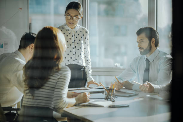 istock Charming boss hearing out her employees in her office 931453910