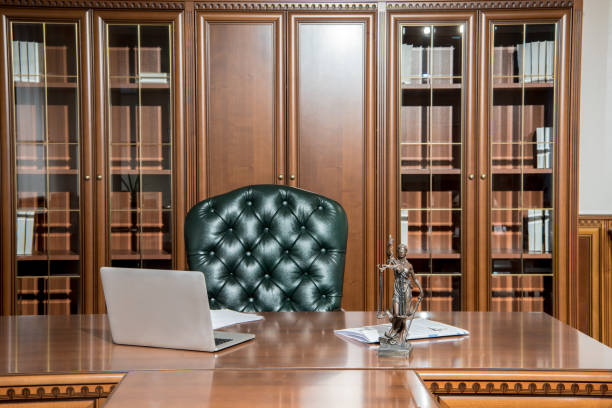 istock Interior of office room with laptop, statuette and papers on table 931454148