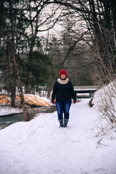 istock Female Wearing Knitted Scarf, Hat, Walking, Geyser Background 931454234