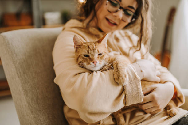 istock Young woman holding cat 931454434
