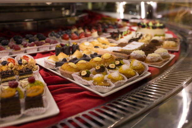 istock Different colorful Tasty beautiful cakes on a show-window in cafe 931454554