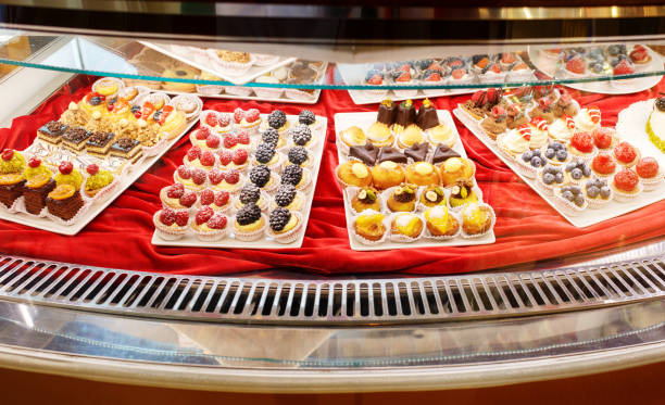 istock Different colorful Tasty beautiful cakes on a show-window in cafe 931454834