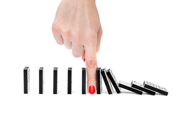istock Woman's hand stopping domino effect on white background. 931457626