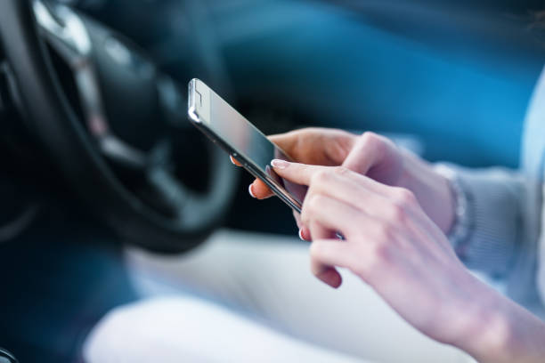 istock Driver using smart phone in the car.Phone and hands are in focus. 931458870