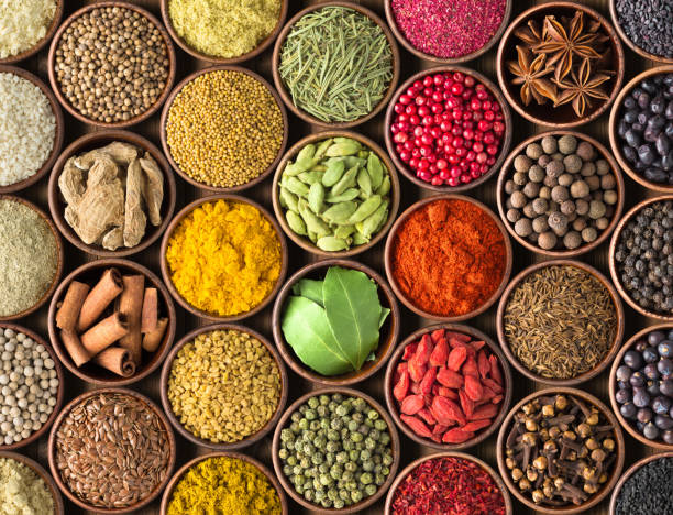 istock Spices and herbs background. Condiments on the table spread out by a rainbow 931464498