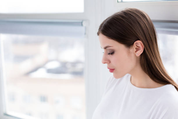 istock Beautiful happy woman sitting by the window 931465214
