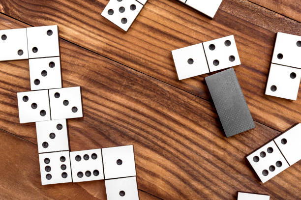 istock Dominoes on brown wooden table. Playing domino. Top view. 931465544