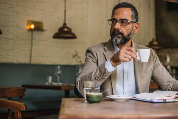 istock Senior businessman in an internet cafe working 931466778