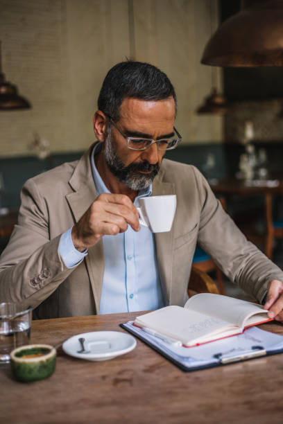 istock Senior businessman in an internet cafe working 931466974