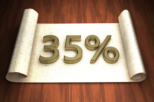 35 per cent, golden numbers, over open paper, 3d rendering