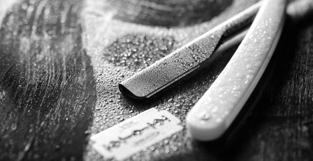 istock A dangerous razor and a metal blade on the table. Men's shaving 931473232