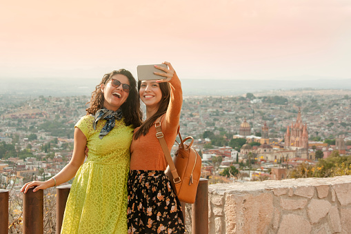 Friends taking a selfie at a viewpoint in San Miguel de Allende, Mexico