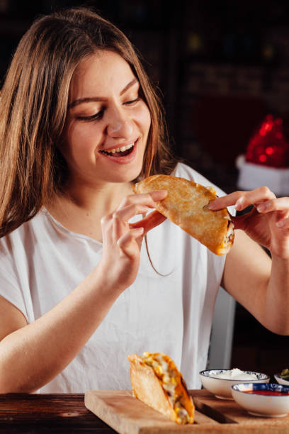 istock Young woman eating taco 931479884