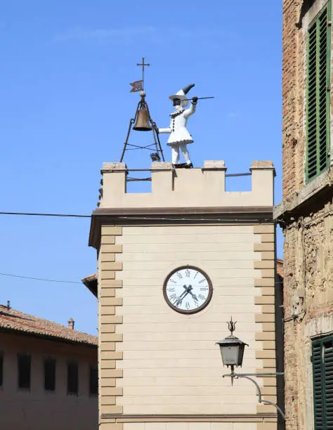 View on the historic Pulcinella Tower with clock in Montepulciano, Tuscany, Italy