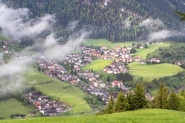 istock Alpine village in the mist clouds 931486676