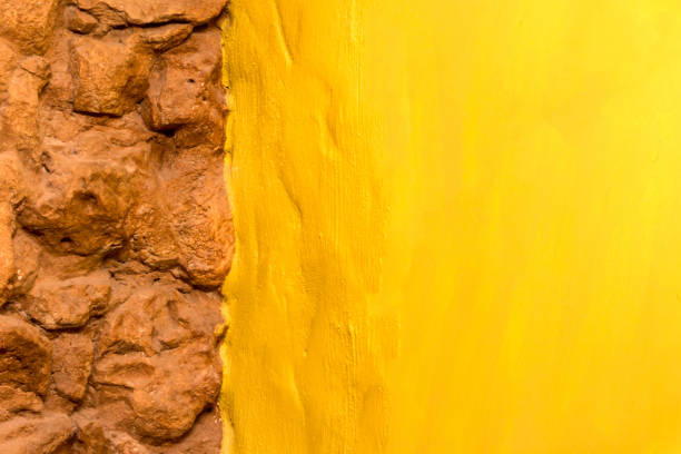 Background texture old brick stone wall and bright yellow painted wall with copy space for text