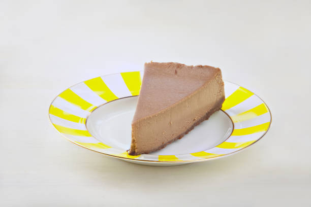 istock chocolate cheesecake on white plate on  wooden table 931486988