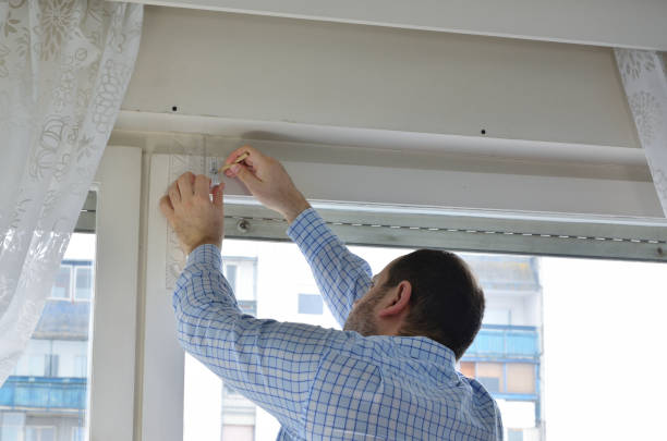 Man measuring a position of a hole