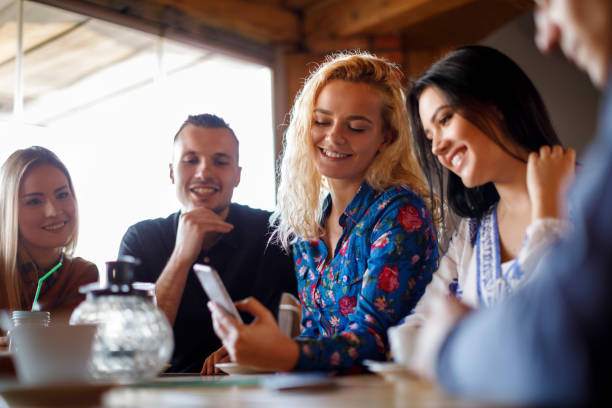 istock Friends at a cafe using a mobile phone 931494138