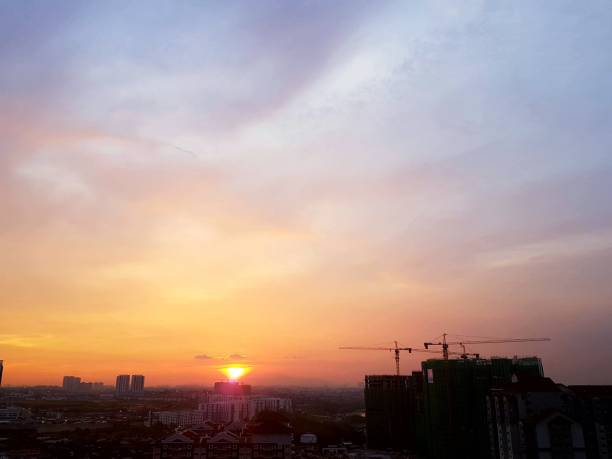 istock Orange sunset over horizon and cityscape with pastel sky 931494312
