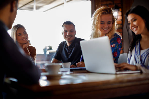 istock Group of college students using laptop at a cafe 931494604