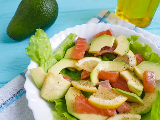 salad with avocado red fish on blue wooden