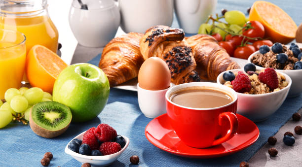 istock Breakfast served with coffee, juice, croissants and fruits 931497532
