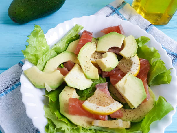 salad with avocado red fish on blue wooden