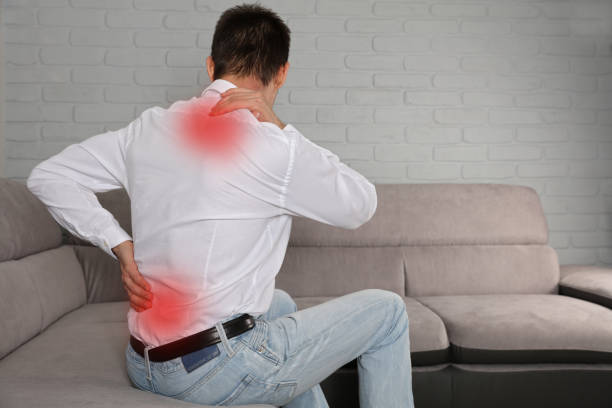 istock Man suffering from back and neck pain. Incorrect sitting posture problems, Muscle spasm, rheumatism. Pain relief, ,chiropractic concept. 931497880