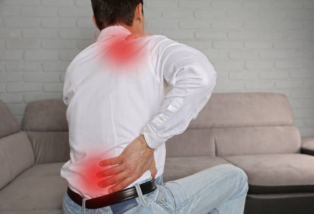 istock Man suffering from back and neck pain. Incorrect sitting posture problems, Muscle spasm, rheumatism. Pain relief, ,chiropractic concept. 931497894