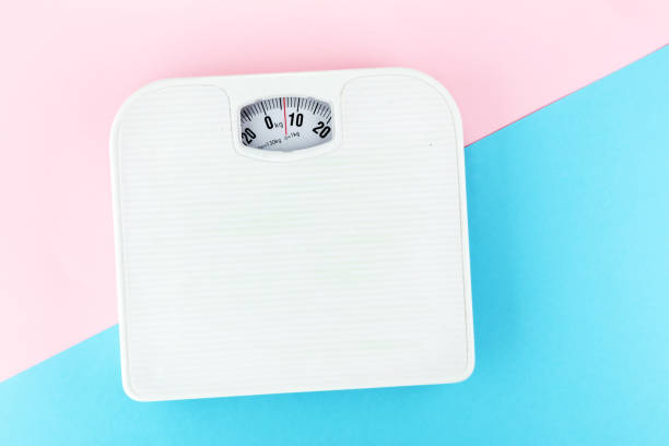 istock weight measure flat lay on colored paper. 931501276