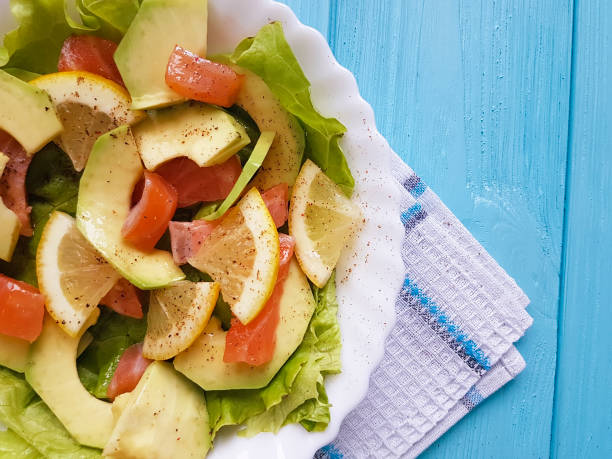 salad with avocado red fish on blue wooden