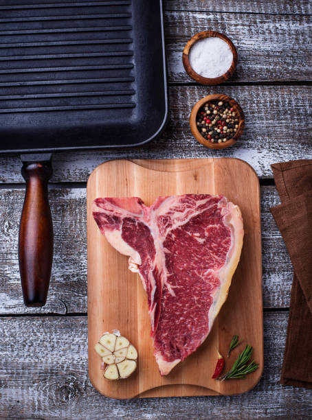 istock Raw T-bone steak and iron grill pan 931502302