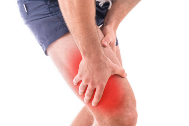 Man with quadriceps pain over white background stock photo