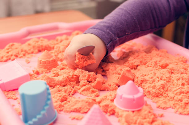istock The hands of a child playing with kinetic sand 931508340