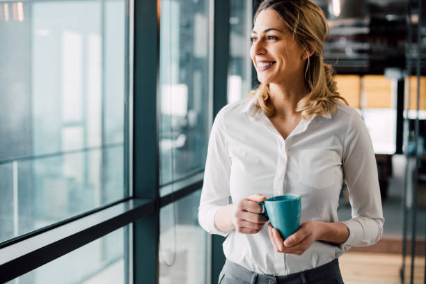 istock Young business woman looking through window 931508800