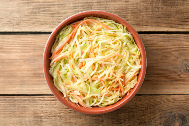 istock Fresh coleslaw salad in bowl on rustic wooden table 931509912