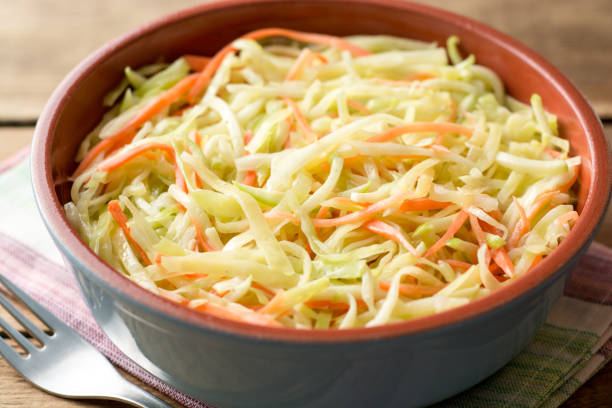 istock Fresh coleslaw salad in bowl on rustic wooden table 931510044
